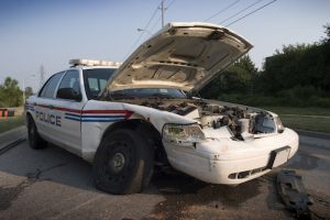 Who is Responsible for Damages When a Person is Injured in a Collision with a Police Car?